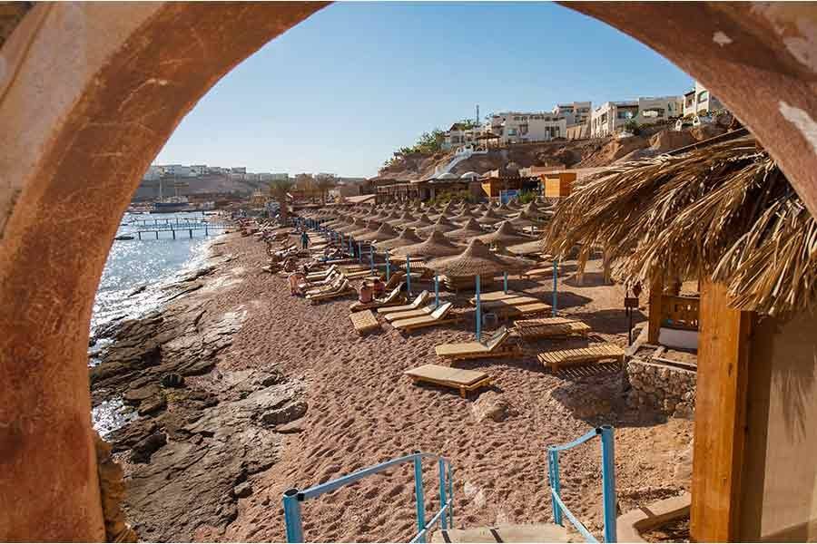 The beach framed by a stone archway