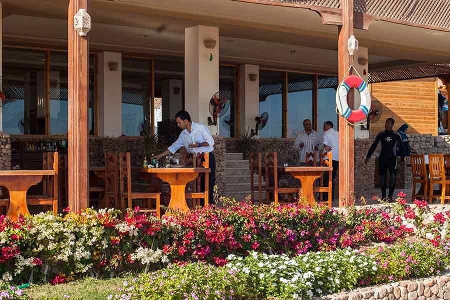 Terrace restaurant with wooden tables and flowers