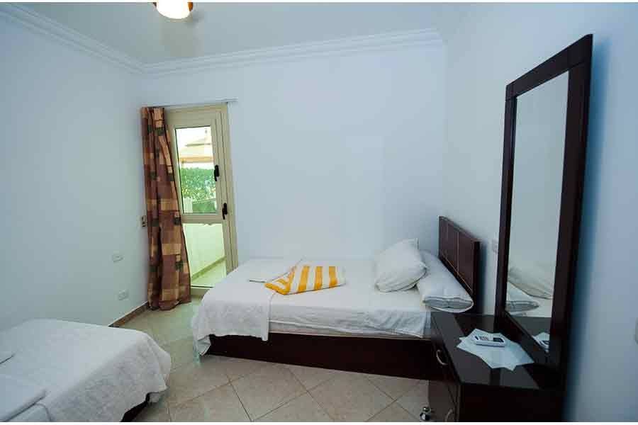 Apartment bedroom with a double bed and balcony door