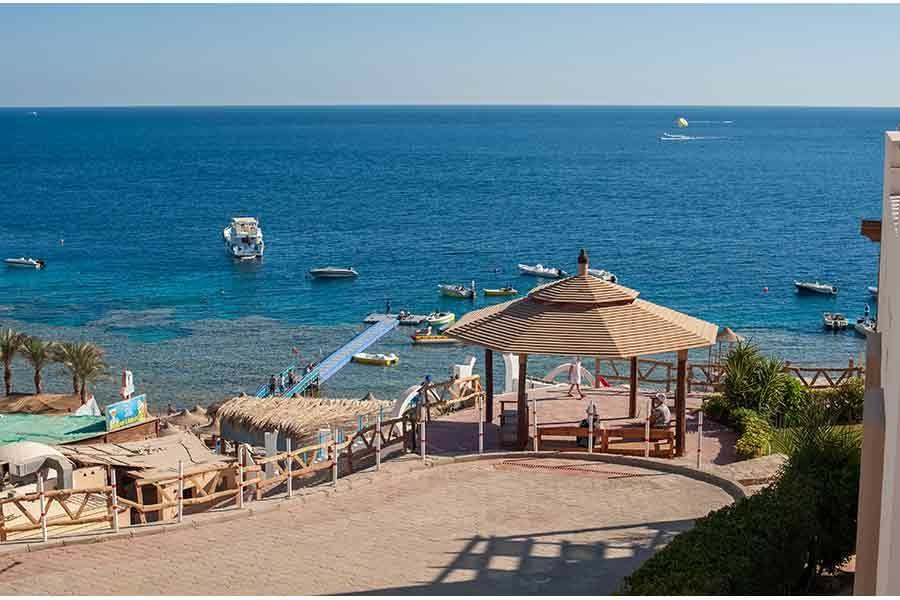 Thatched gazebo on the beach terrace above the sea