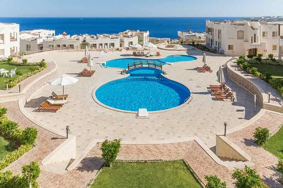 Pools and lawns stepping down towards the sea