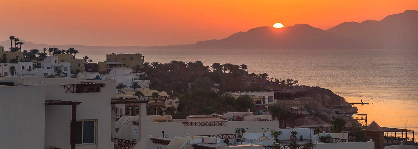 Low sun over the Red Sea and the mountains of Tiran Island, seen from Shark’s Bay